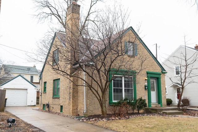 front facade featuring a garage and an outdoor structure