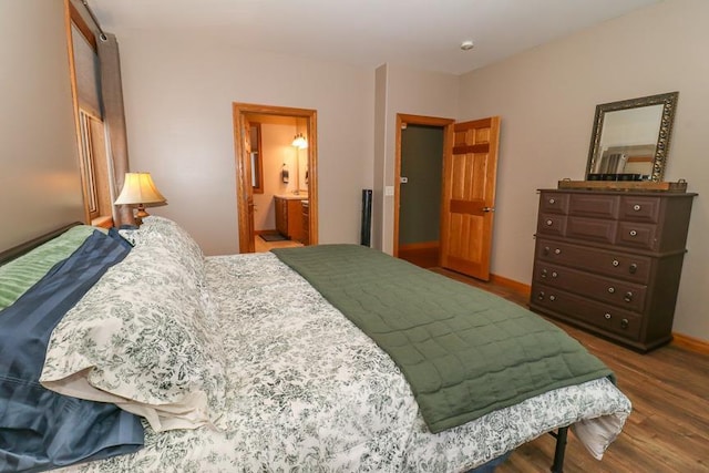 bedroom with wood-type flooring and ensuite bath