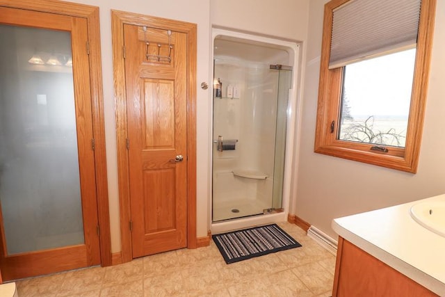 bathroom featuring an enclosed shower and vanity