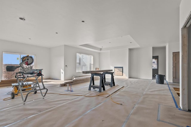 recreation room with a raised ceiling