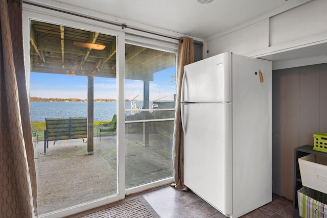 kitchen with a water view and white fridge