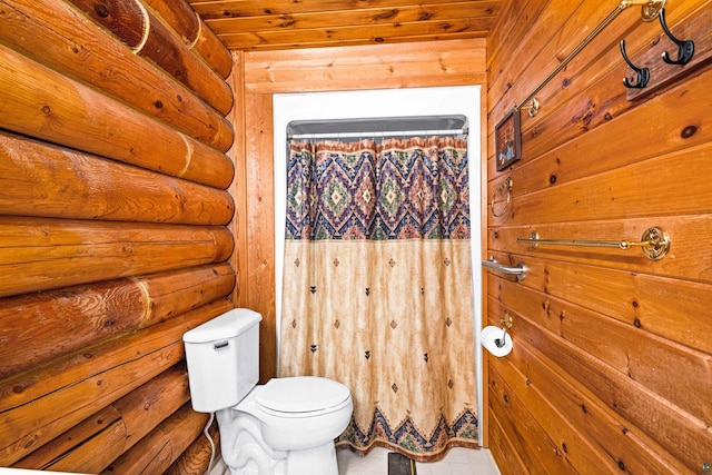 bathroom featuring log walls and toilet