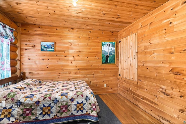 unfurnished bedroom featuring rustic walls, hardwood / wood-style floors, and wooden ceiling