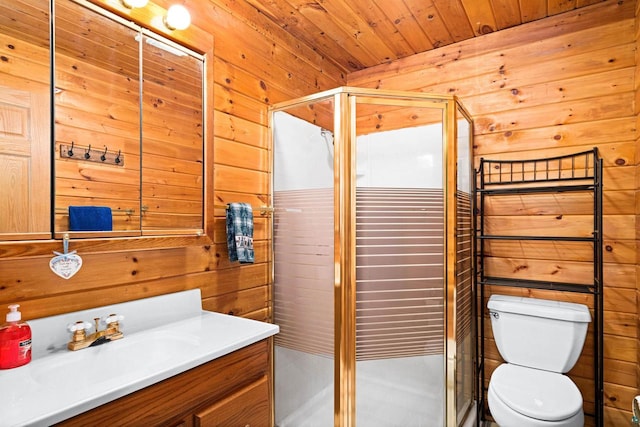 bathroom featuring toilet, vanity, wooden walls, and walk in shower