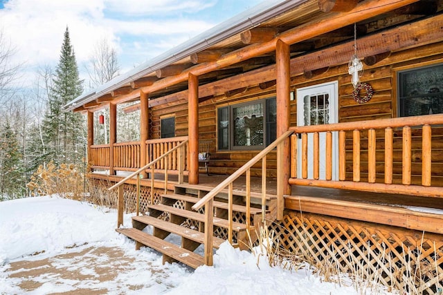 view of snow covered property entrance