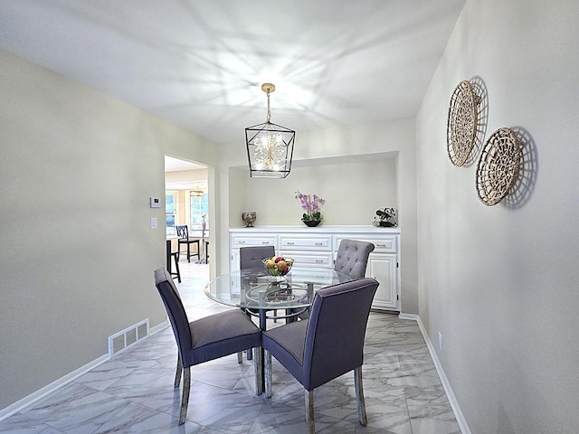 dining area with an inviting chandelier