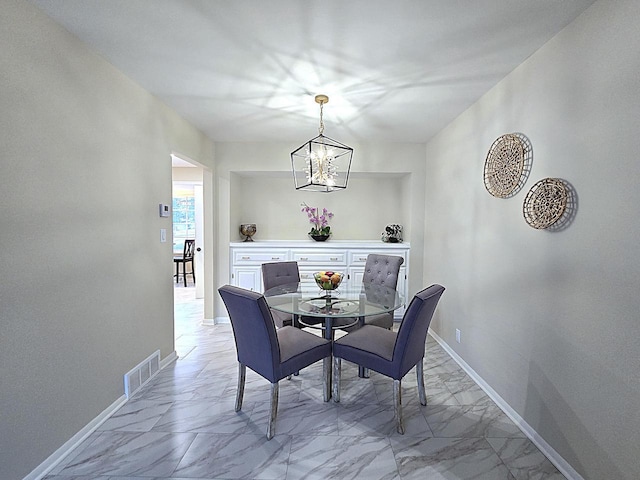 dining space with a notable chandelier