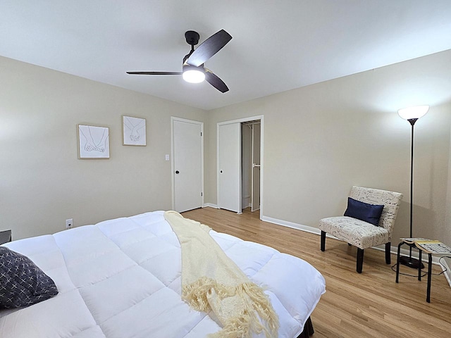 bedroom with ceiling fan, light hardwood / wood-style floors, and a closet