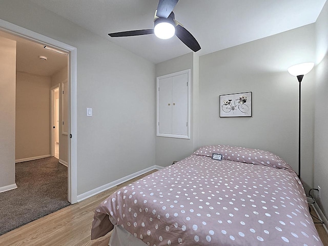 bedroom with wood-type flooring and ceiling fan