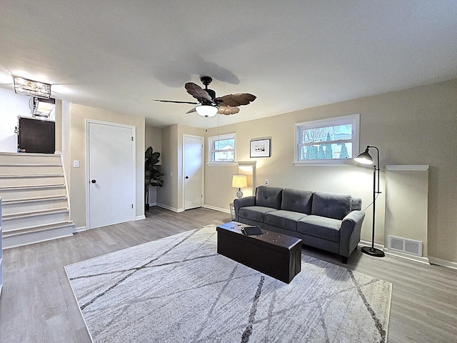 living room featuring ceiling fan and hardwood / wood-style floors