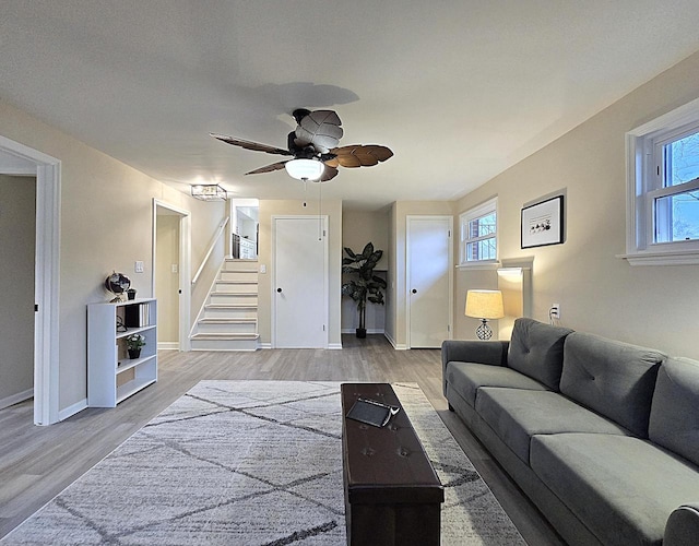 living room with ceiling fan, plenty of natural light, and hardwood / wood-style floors