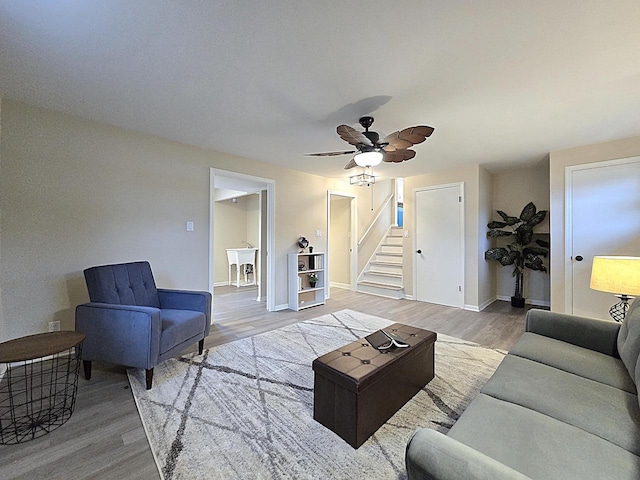 living room featuring hardwood / wood-style floors, sink, and ceiling fan