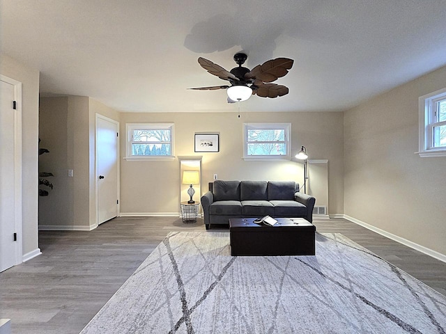 living room featuring hardwood / wood-style floors, a wealth of natural light, and ceiling fan