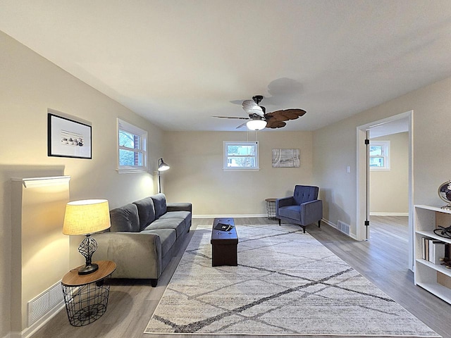 living room featuring ceiling fan and light hardwood / wood-style floors