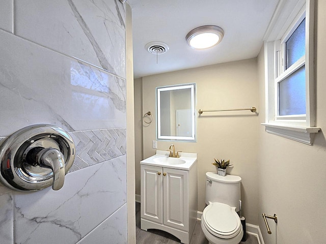 bathroom featuring vanity and toilet