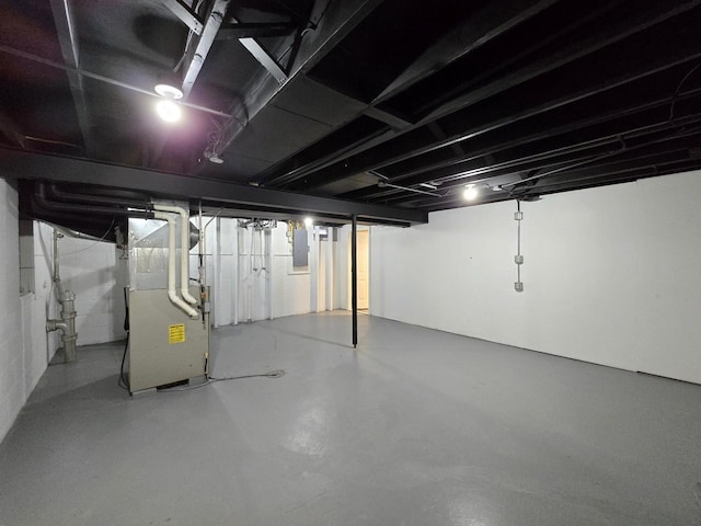 basement with heating unit and electric panel