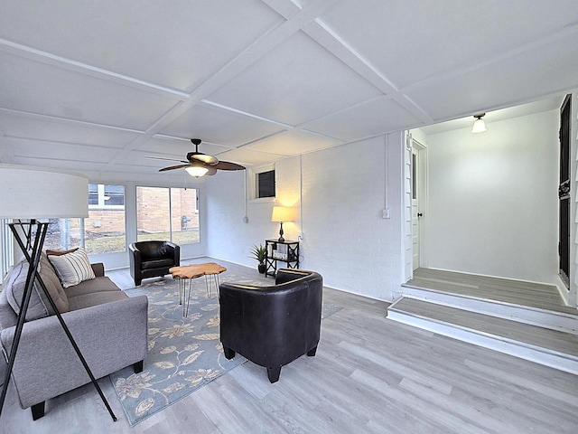 living room featuring ceiling fan, coffered ceiling, and hardwood / wood-style floors