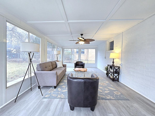 sunroom with coffered ceiling and ceiling fan