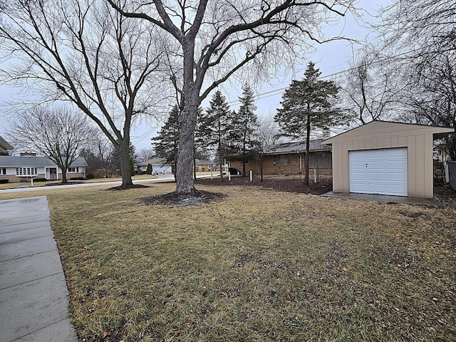 view of yard featuring an outbuilding and a garage