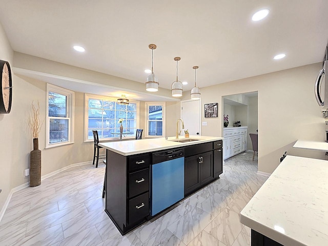 kitchen featuring a kitchen island with sink, decorative light fixtures, dishwasher, and sink