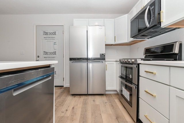 kitchen featuring white cabinetry, appliances with stainless steel finishes, and light wood-type flooring