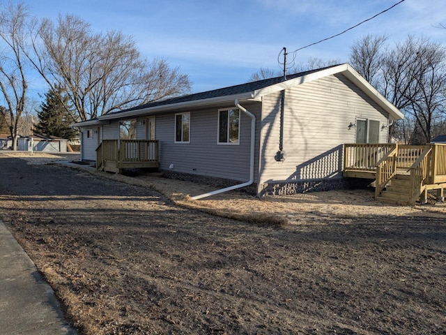 view of side of property featuring a wooden deck