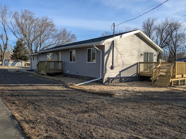 view of property exterior featuring a wooden deck