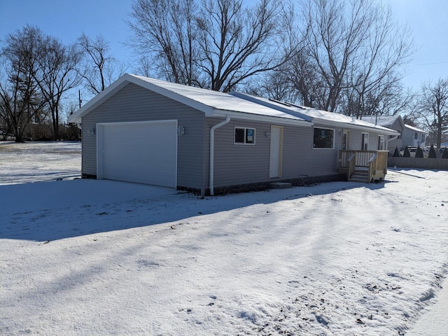 snow covered property featuring a garage