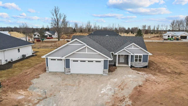 craftsman house featuring a garage, stone siding, and dirt driveway