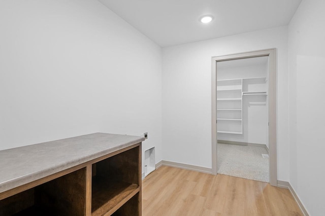 spacious closet featuring light hardwood / wood-style floors