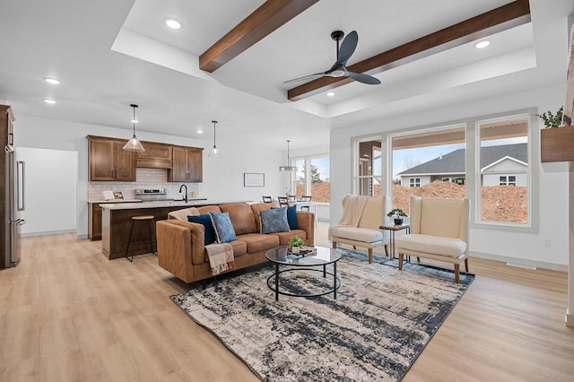 living room featuring recessed lighting, a ceiling fan, baseboards, light wood finished floors, and beamed ceiling