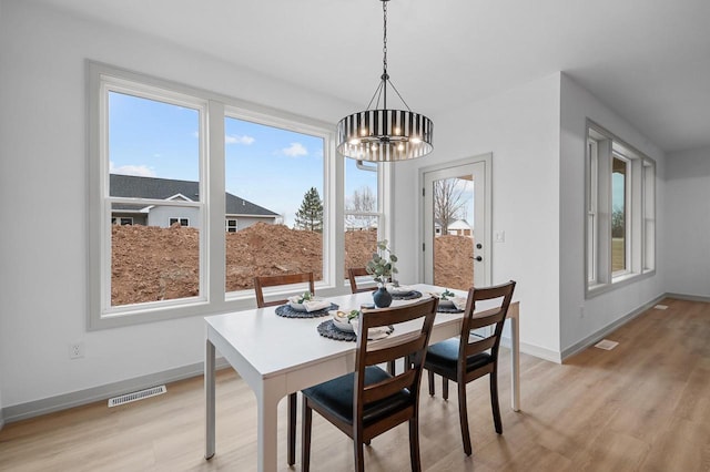 dining area featuring a chandelier and light wood-type flooring