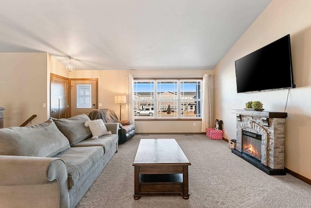 carpeted living room with lofted ceiling and a fireplace