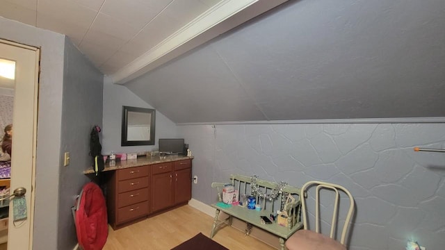 bathroom featuring lofted ceiling, wood-type flooring, and vanity