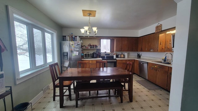 3290 Lark Rd, Greenleaf, WI 54126 - kitchen featuring appliances with stainless steel finishes, decorative light fixtures, sink, and a notable chandelier