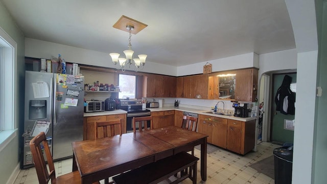 3290 Lark Rd, Greenleaf, WI 54126 - kitchen featuring hanging light fixtures, appliances with stainless steel finishes, sink, and a notable chandelier