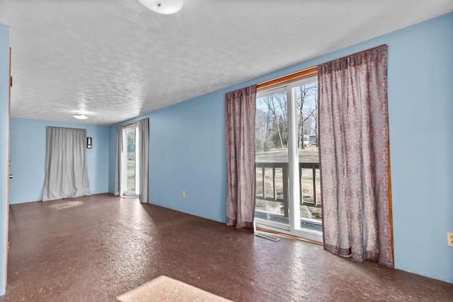 spare room featuring a textured ceiling