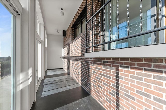 stairway featuring brick wall