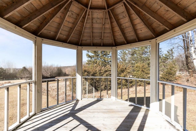 unfurnished sunroom featuring wood ceiling and lofted ceiling with beams