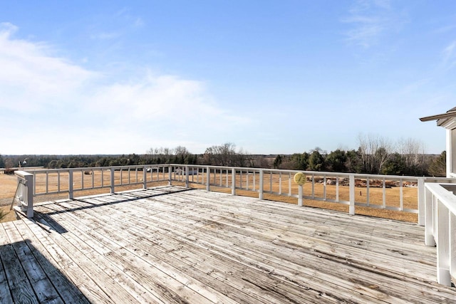 wooden deck with a rural view