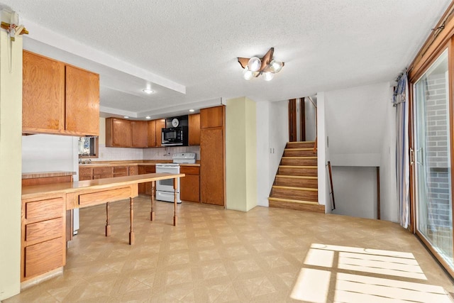 kitchen with white range with electric cooktop and a textured ceiling