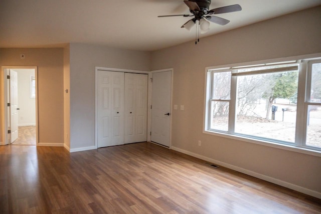 unfurnished bedroom with ceiling fan and wood-type flooring