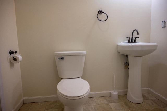 bathroom with tile patterned flooring, sink, and toilet