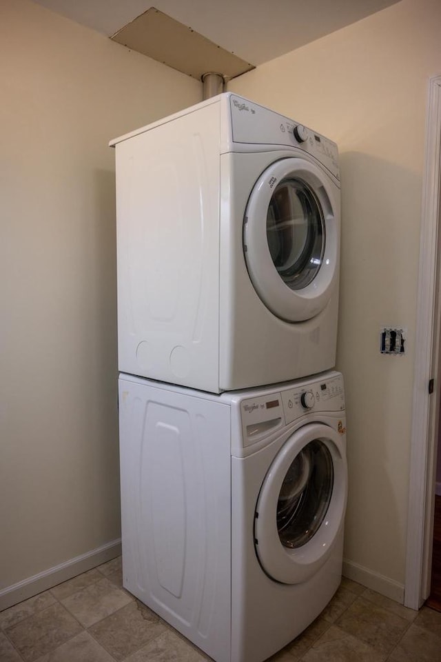 laundry area featuring stacked washer / dryer