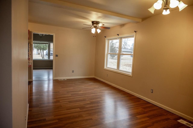 spare room with ceiling fan, a healthy amount of sunlight, dark hardwood / wood-style flooring, and beam ceiling