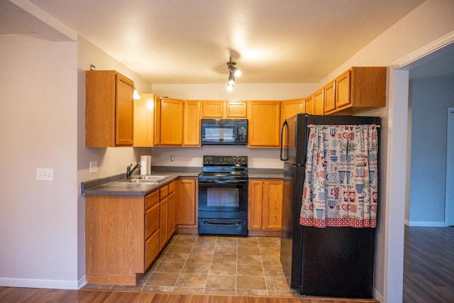 kitchen with sink and black appliances