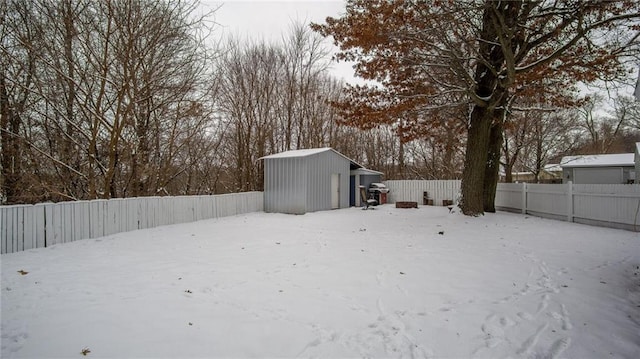 snowy yard with a shed