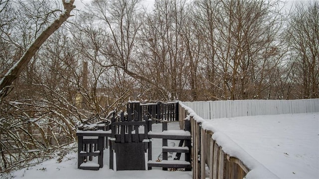 snow covered deck with a playground