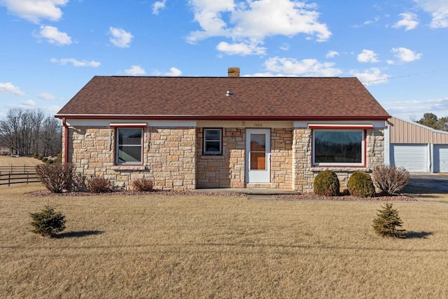 ranch-style house with a garage and a front yard