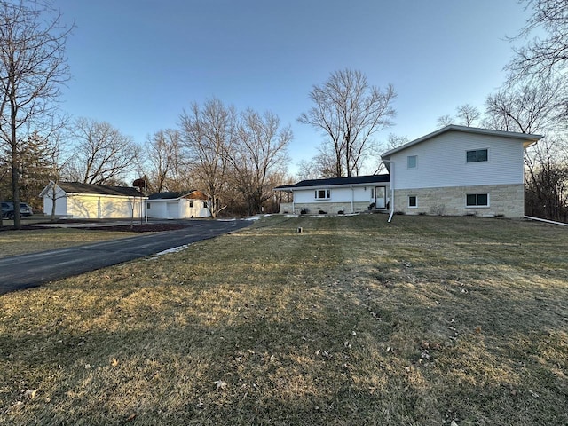 view of property exterior with a storage shed and a lawn